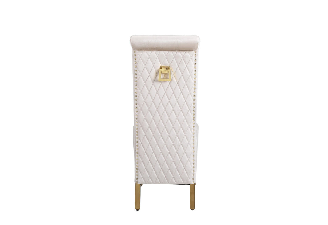 A beige upholstered dining chair with a gold-colored metal frame and a square knocker on the backrest.