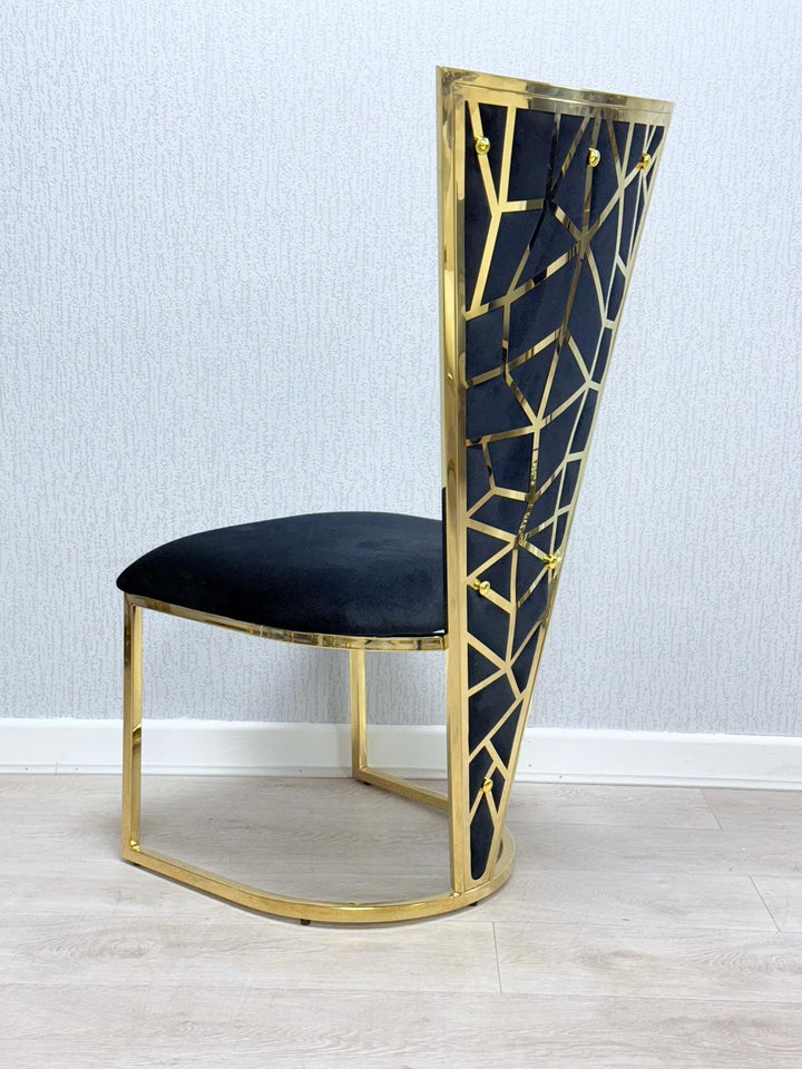 A Vienna black and gold dining chair with a upholstered seat and a geometric patterned backrest in gold tone.