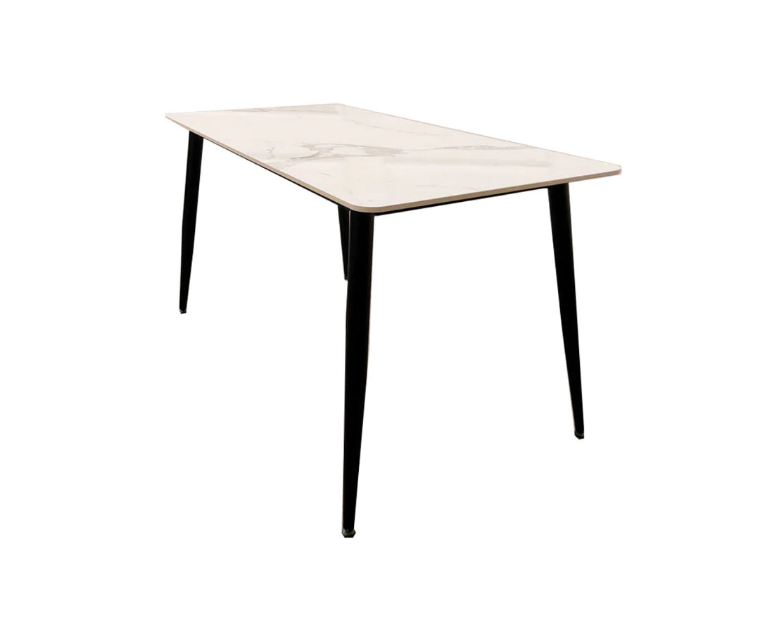 A black dining table with a white sintered stone top, featuring a minimalist design with tapered legs.
