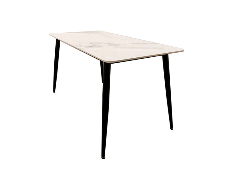 A black dining table with a white sintered stone top, featuring a minimalist design with tapered legs.