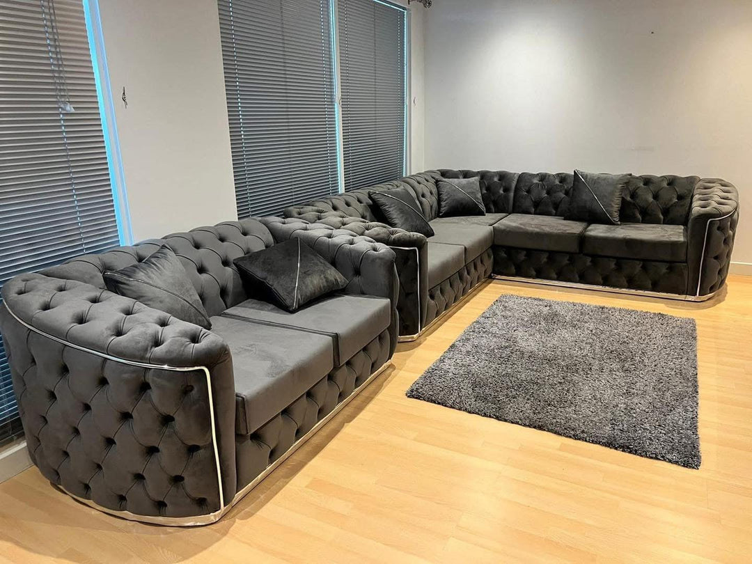 A set of dark grey and chrome sofas with tufted detailing, consisting of a 3-seater sofa and a 2-seater sofa, both with a gold-colored metal frame.