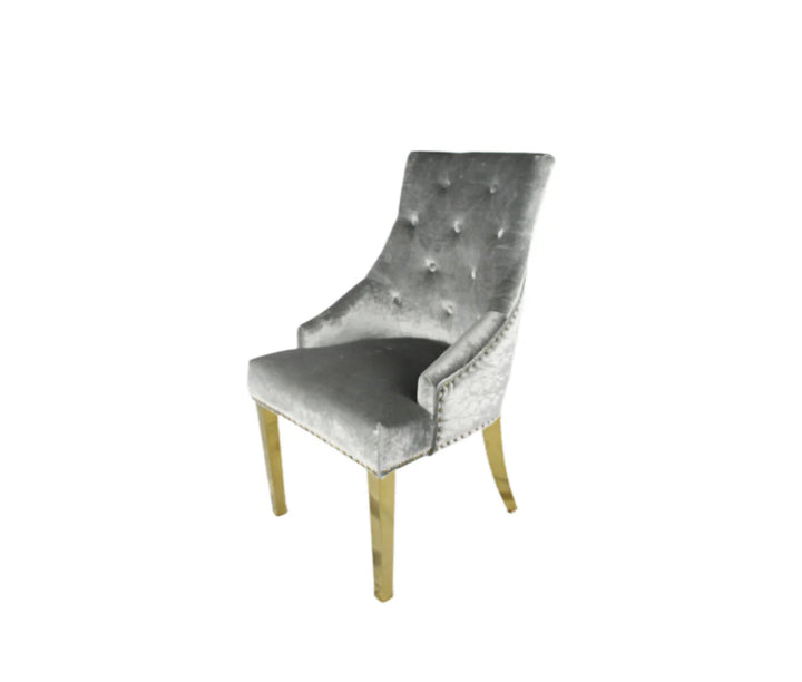 A silver dining chair with gold accents and upholstered backrest, seated on a wooden leg.