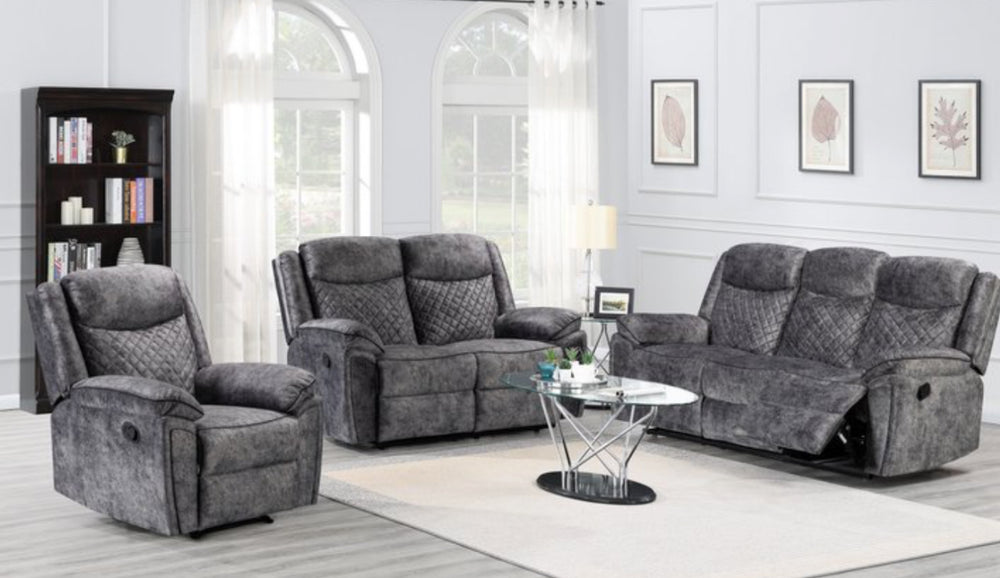 A silver grey leather recliner sofa set consisting of a three-seater sofa, a two-seater sofa, and an armchair, arranged in a living room setting with a center table.