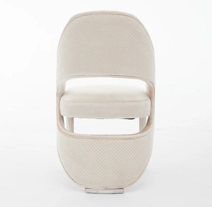 a luxury cream dining chair with silver leg back design