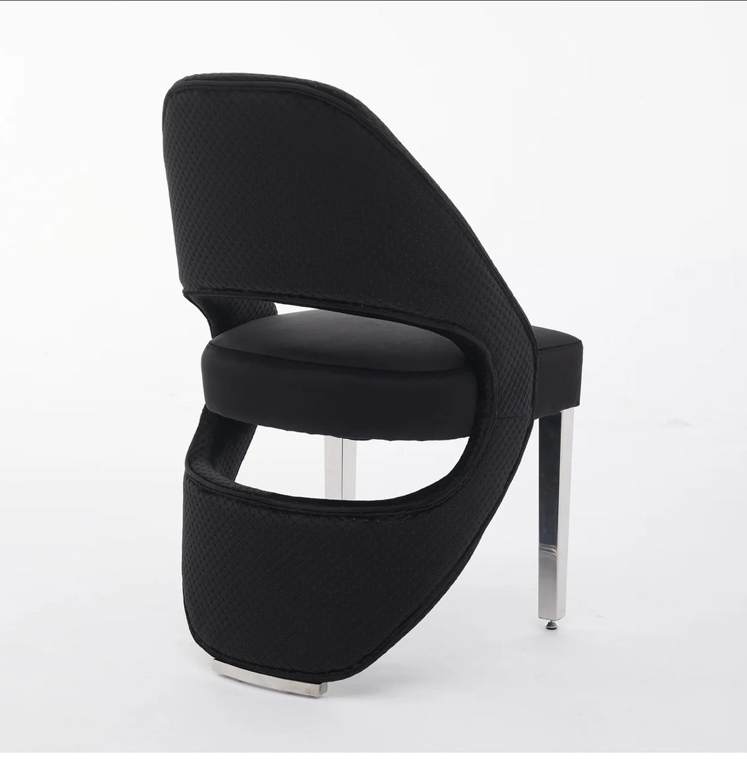 A gray plush velvet dining chair with chrome legs.