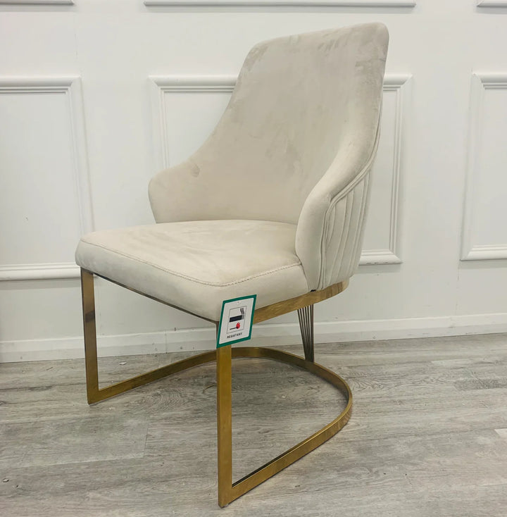 A pair of Chelmsford mink velvet dining chairs with gold stainless steel legs, featuring a ribbed stitch design on the backrest.