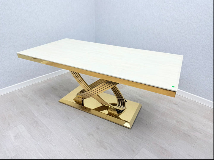 a white marble table with a gold frame and leg