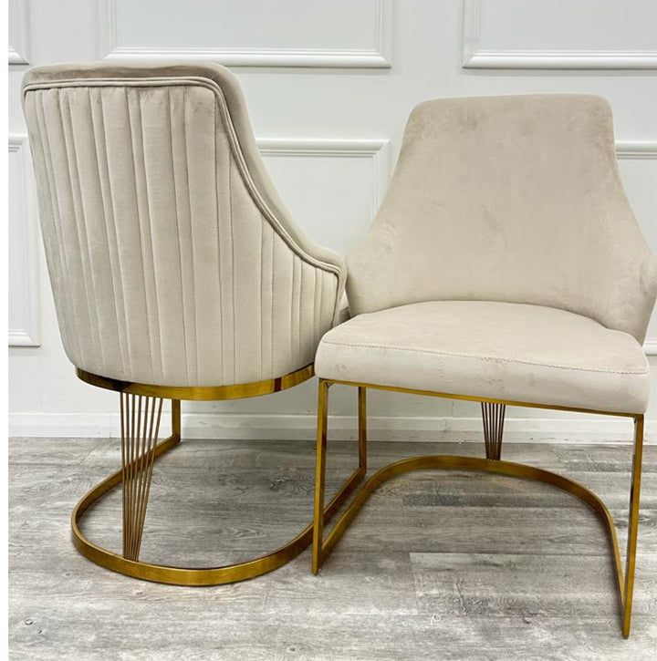 A pair of Chelmsford mink velvet dining chairs with gold stainless steel legs, featuring a ribbed stitch design on the backrest.