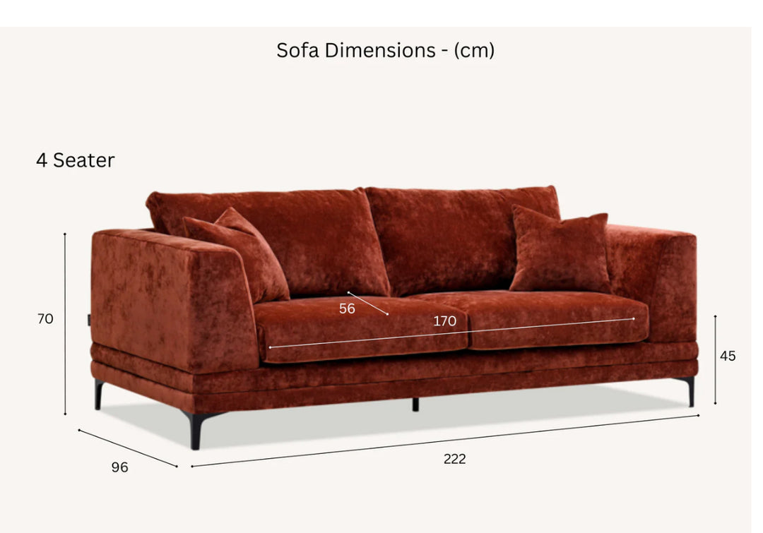 Modern red velvet sofa with square arms, plush cushions, and matching throw pillows on black metal legs