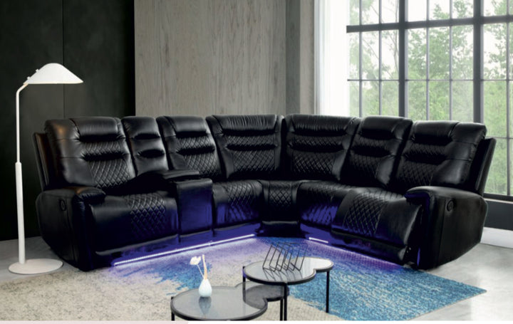 Black leather sectional sofa in a modern living room with a lamp and coffee table.