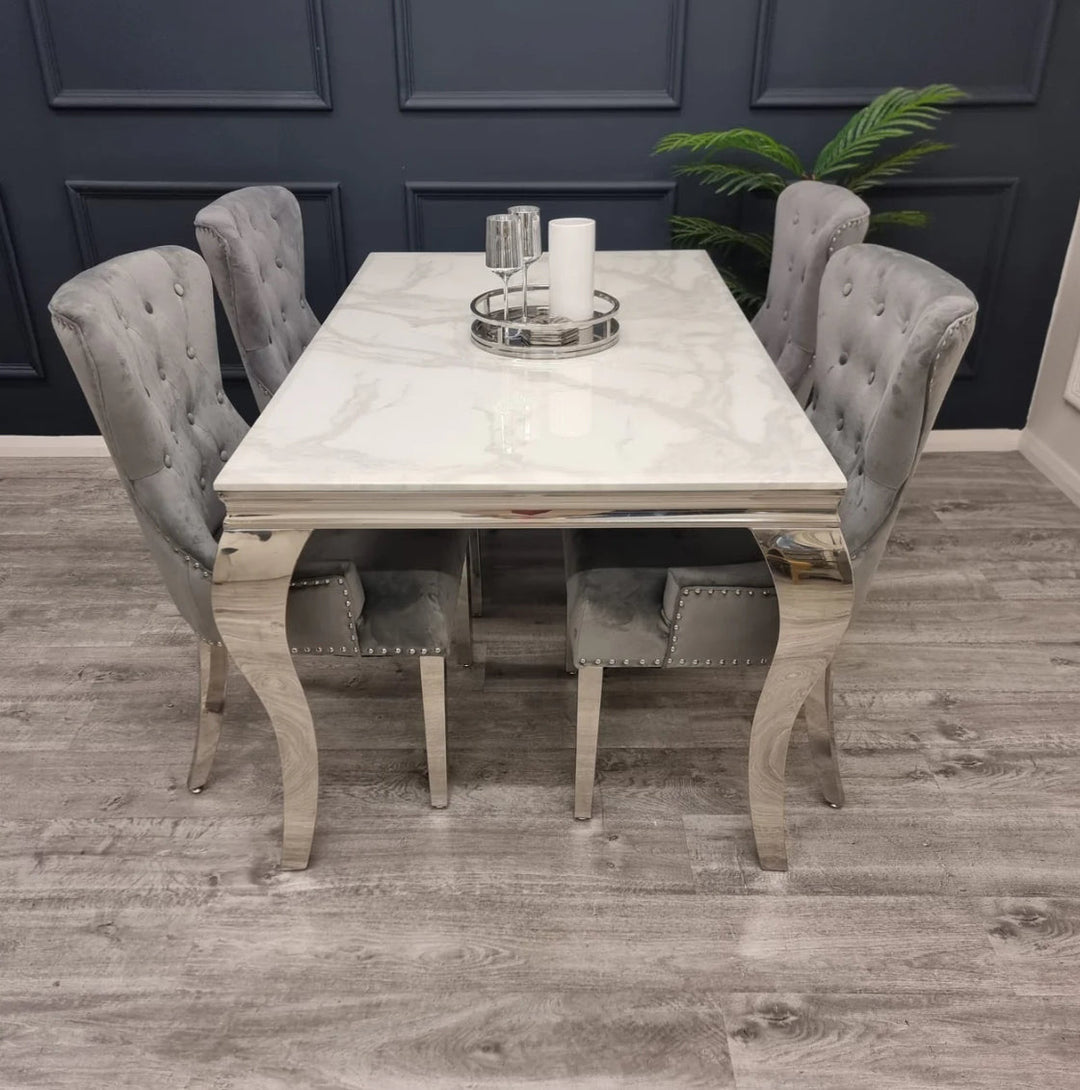 beautiful dining set in a dining room which have a  white marble in a dining top and beige color leg with 4 chair