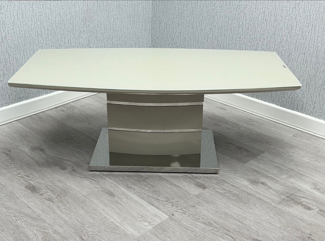 A modern gray coffee table with a beige top, set against a wall on a wooden floor.