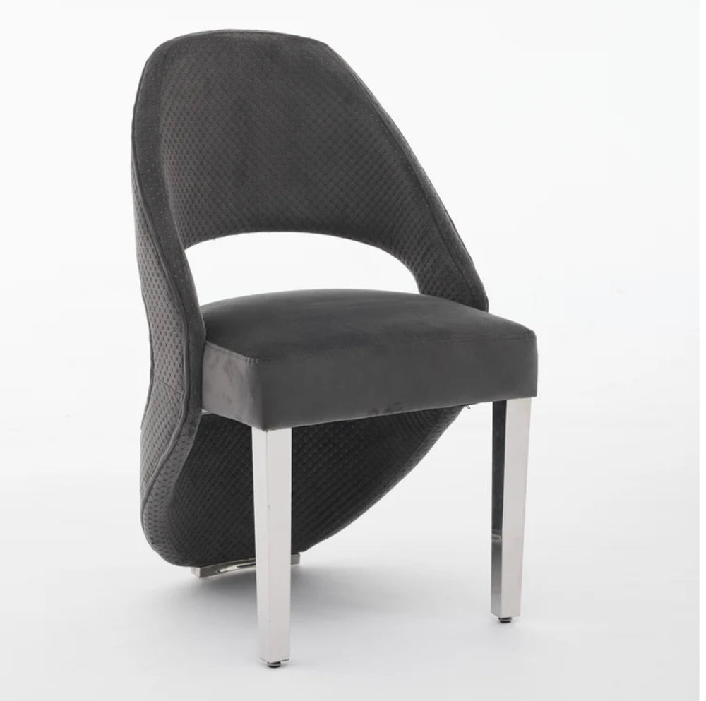 A gray plush velvet dining chair with chrome legs.
