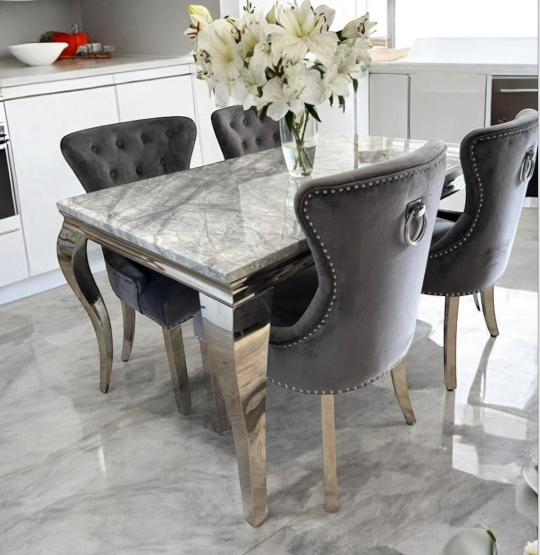 a grey marble luxury dining table with 4 luxury chair in a dining room