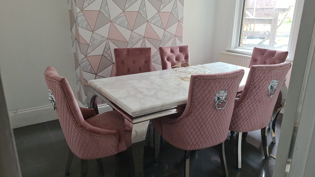 pink color dining chair and cream color marble color dining top with chrome color leg