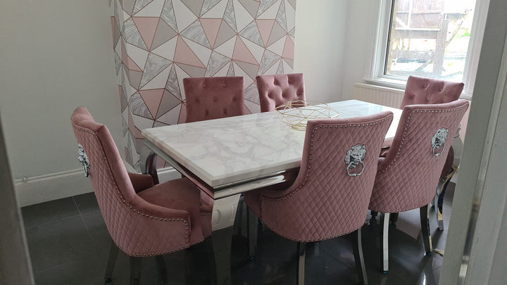 pink color dining chair and cream color marble color dining top with chrome color leg