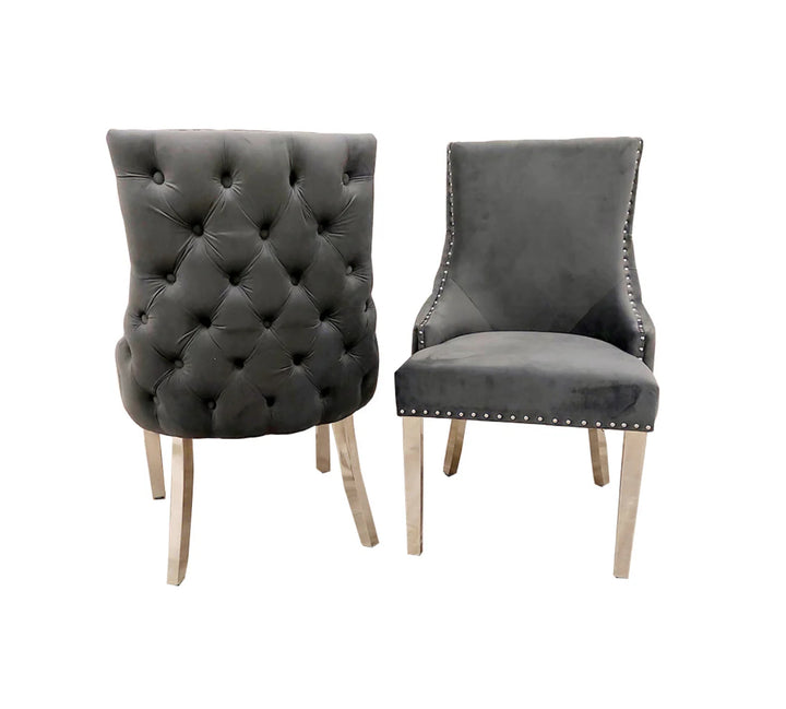 Two Kensington Dining Chairs in dark grey velvet, featuring stud detailing along the border, high quality chrome straight legs, and deep buttoned stitching back design.