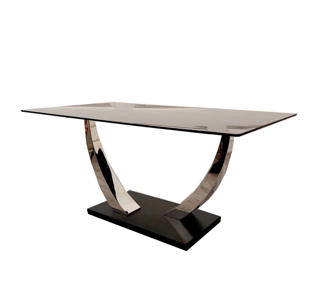 Contemporary black dining table with glossy rectangular top and curved chrome legs on a solid black base