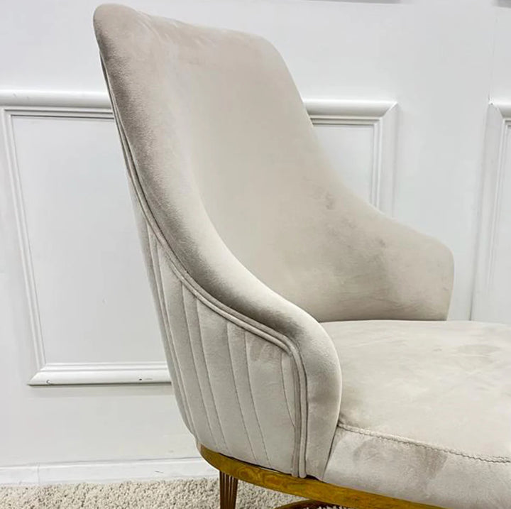A pair of Chelmsford mink velvet dining chairs with gold stainless steel legs, featuring a ribbed stitch design on the backrest.