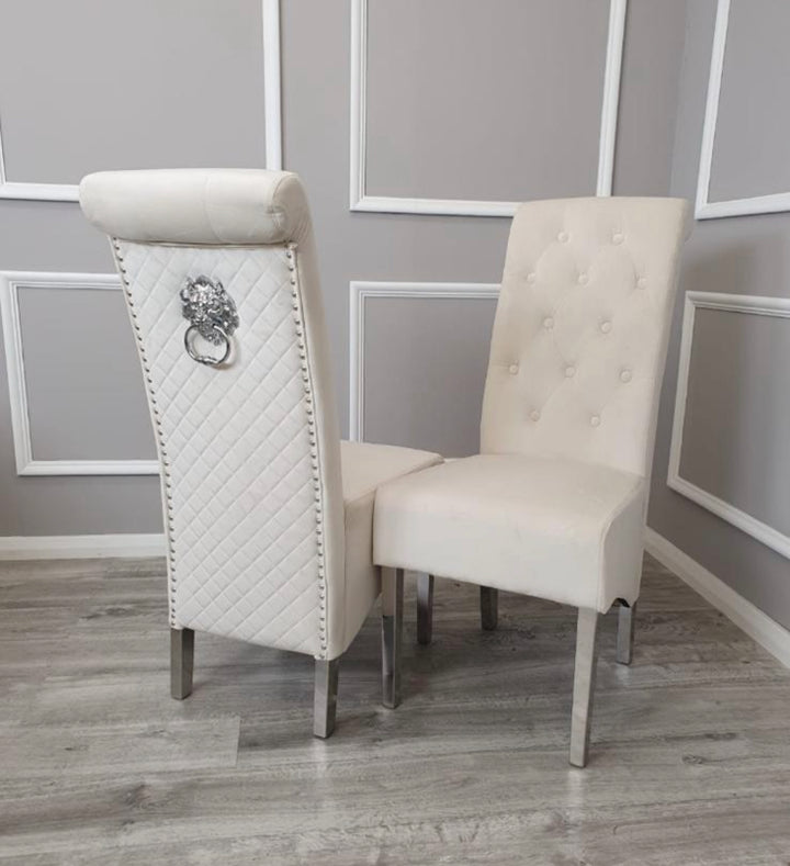 Two cream-colored chairs with decorative backrests in a room with gray walls and wooden flooring.