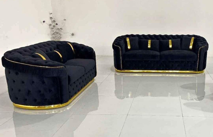 A set of black and gold sofas with tufted detailing, consisting of a 3-seater sofa and a 2-seater sofa, both with a gold-colored metal frame.