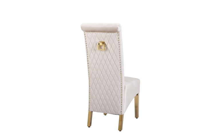 A beige upholstered dining chair with a gold-colored metal frame and a square knocker on the backrest.