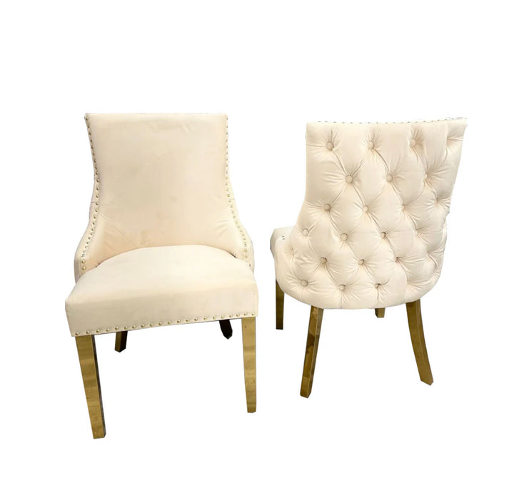 Two Kensington cream dining chairs with gold legs and deep buttoned back design, one showing the side profile and the other showing the back detail.