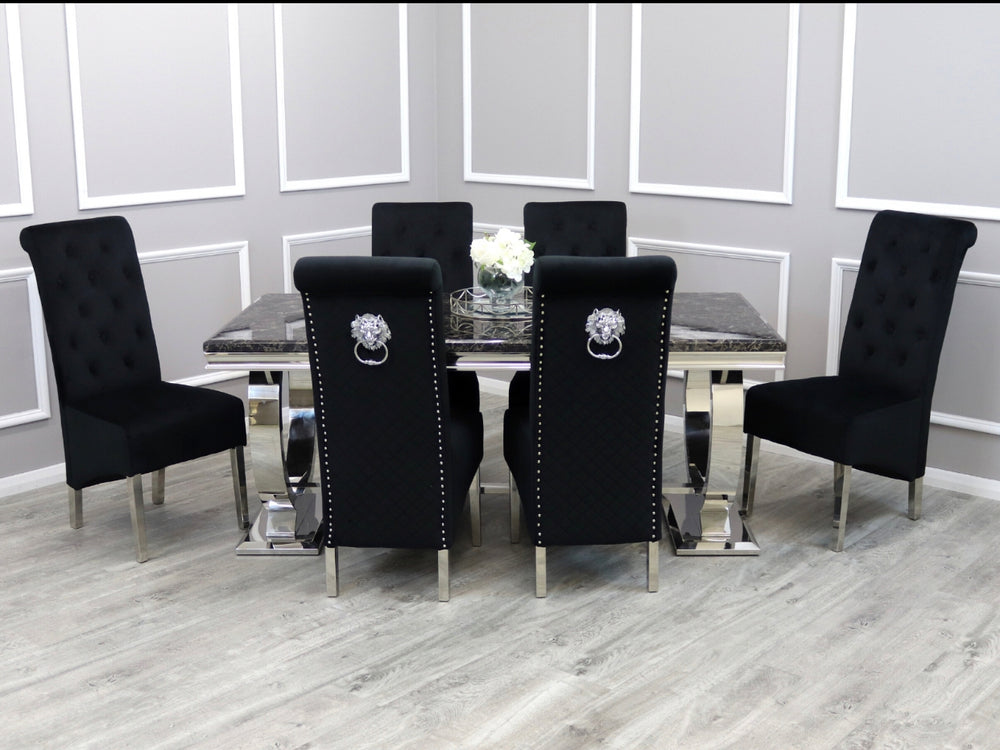 A black dining set with a marble top and steel chrome legs, including a flower vase and decorative knocker, set in a stylishly furnished dining room.