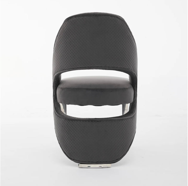 A gray plush velvet dining chair with chrome legs.