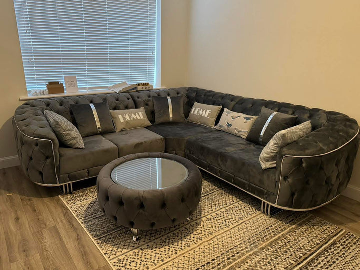 A set of dark grey and chrome sofas with tufted detailing, consisting of a 3-seater sofa and a 2-seater sofa, both with a gold-colored metal frame.