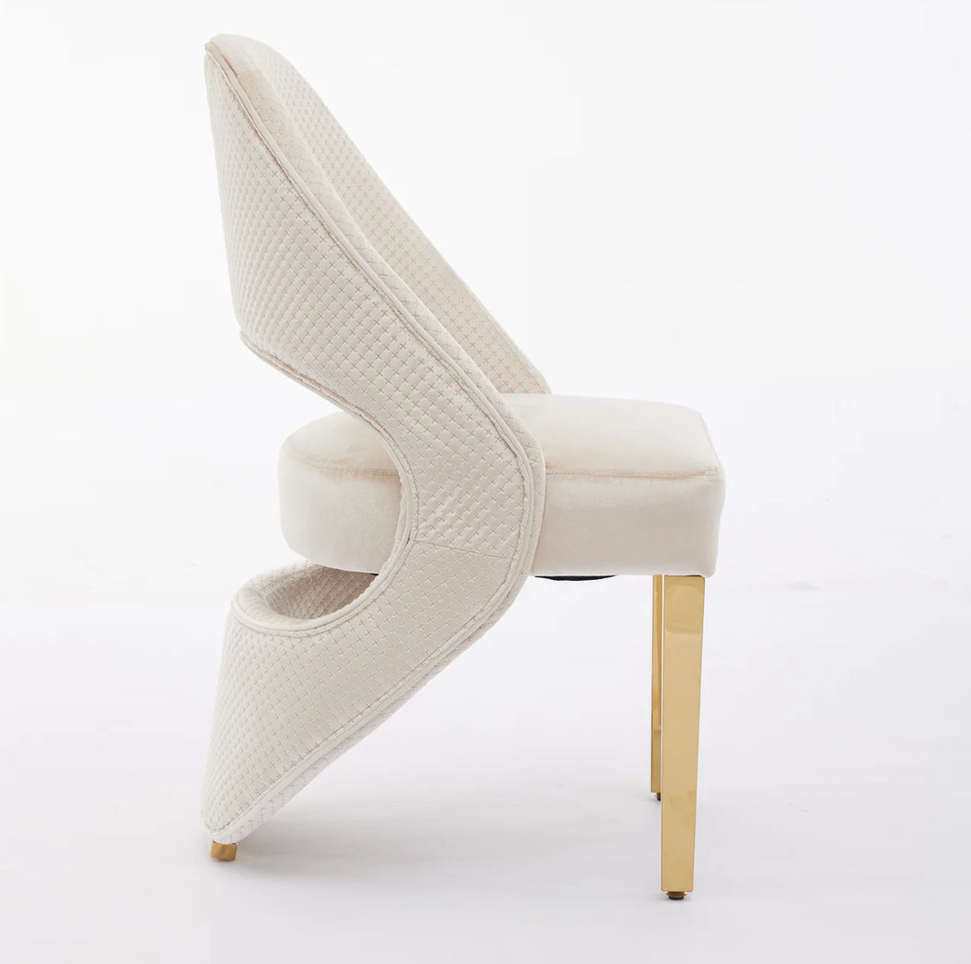 A cream plush velvet dining chair with chrome legs, viewed from a right side angle against a white background.