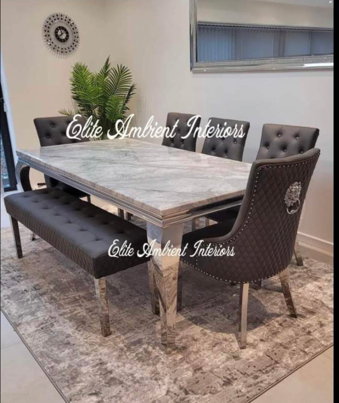 dark grey color dining chair and cream color marble color dining top with chrome color leg