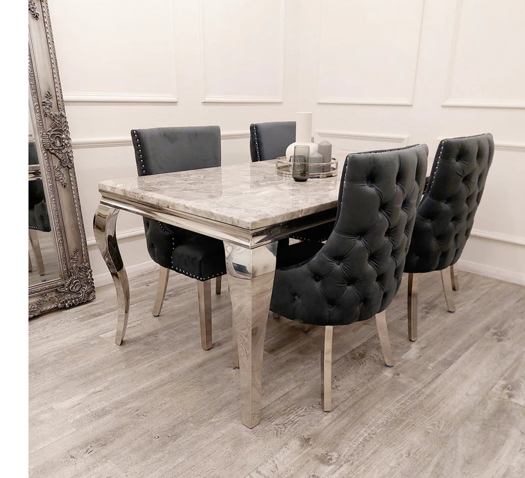 Two Kensington Dining Chairs in dark grey velvet, featuring stud detailing along the border, high quality chrome straight legs, and deep buttoned stitching back design. a dining chair with beige color top and chrome color leg