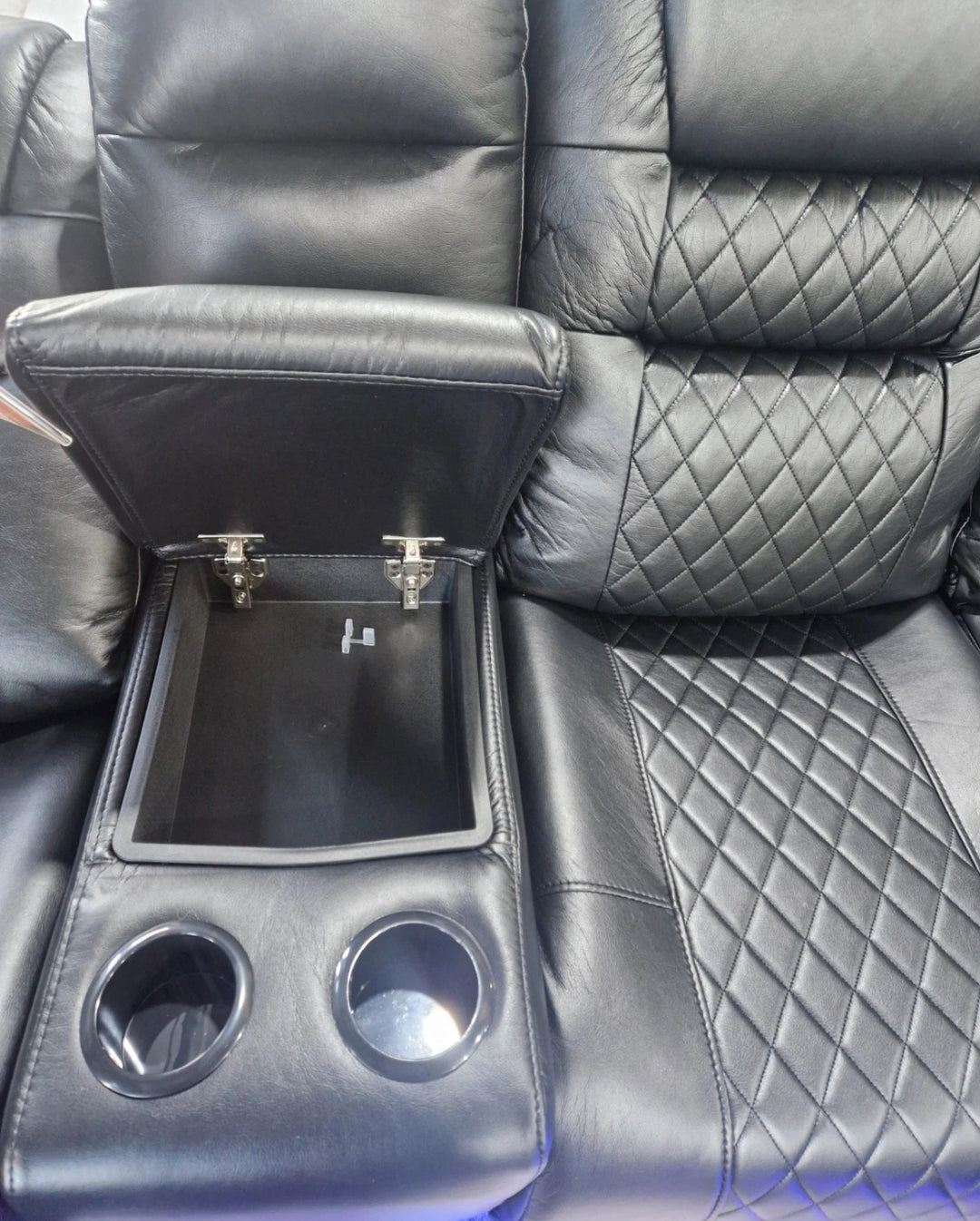 Black leather car seat with cup holders and storage compartment