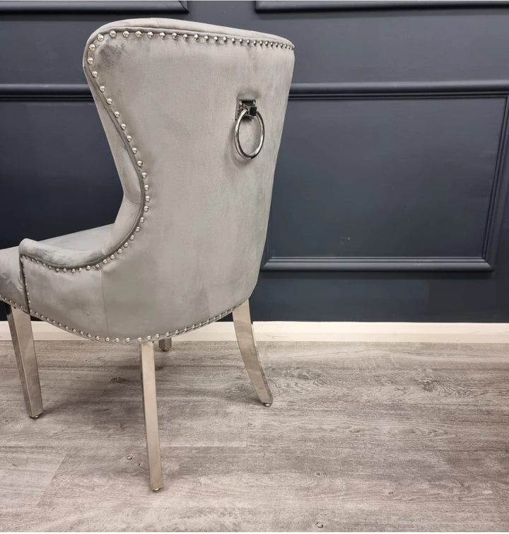 a nice and back side view of a dining chair in a  dining room