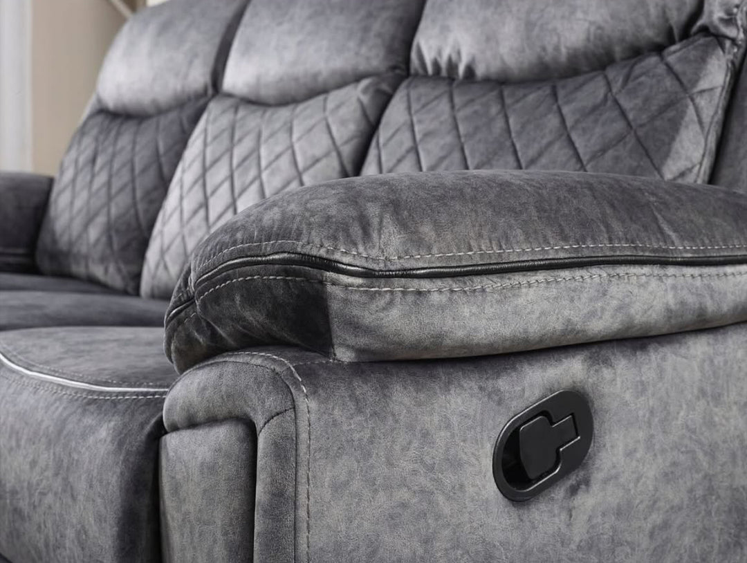 A silver grey leather recliner sofa set consisting of a three-seater sofa, a two-seater sofa, and an armchair, arranged in a living room setting with a center table.