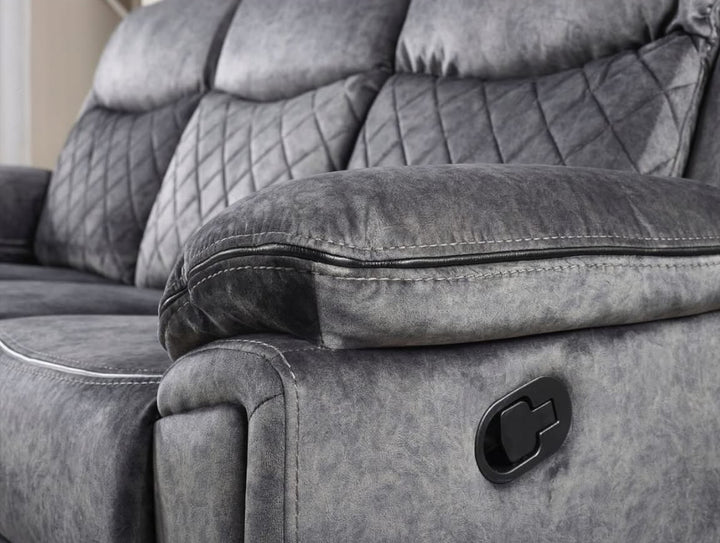 A silver grey leather recliner sofa set consisting of a three-seater sofa, a two-seater sofa, and an armchair, arranged in a living room setting with a center table.