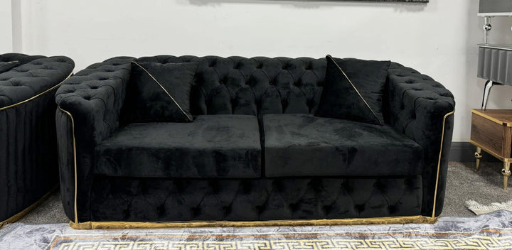 A set of black and gold sofas with tufted detailing, consisting of a 3-seater sofa and a 2-seater sofa, both with a gold-colored metal frame.