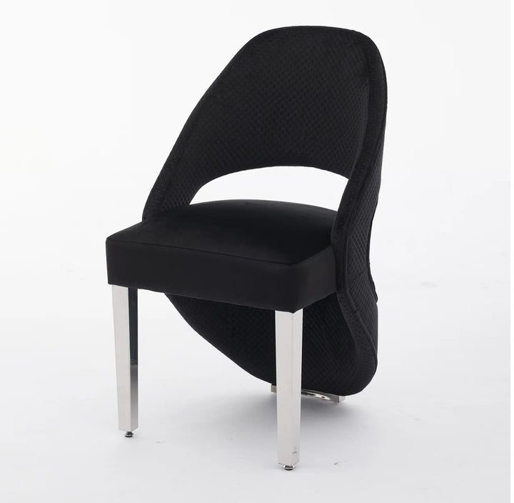 A gray plush velvet dining chair with chrome legs.