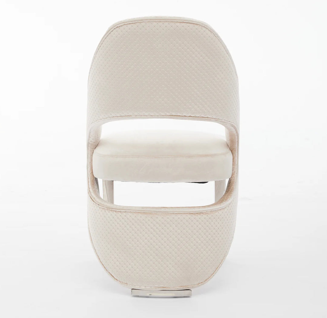 a luxury cream dining chair with silver leg back design