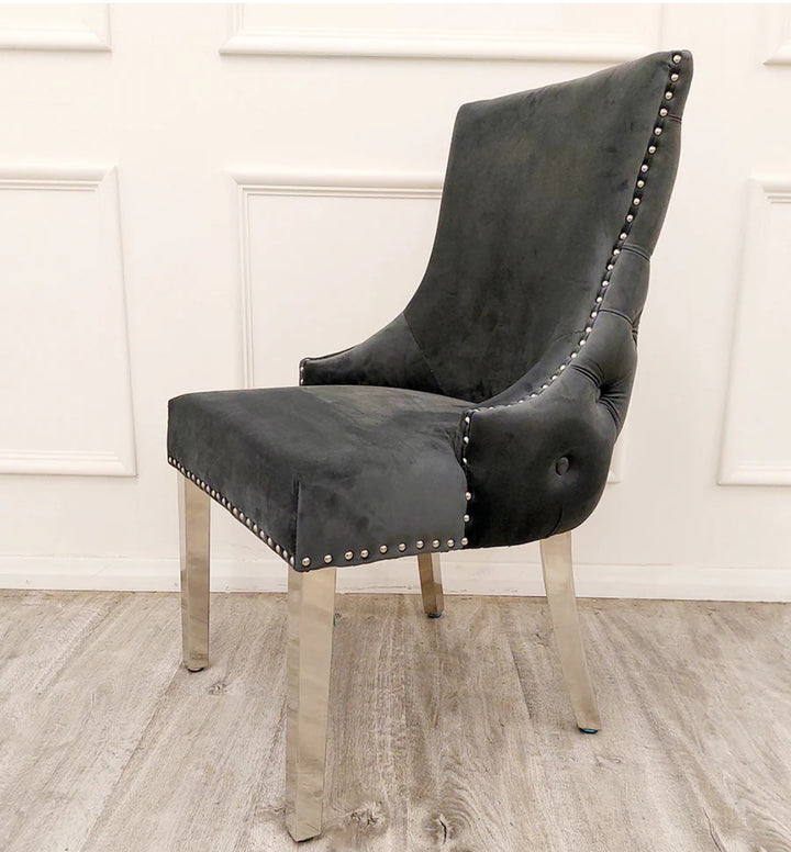 Kensington Dining Chairs in dark grey velvet, featuring stud detailing along the border, high quality chrome straight legs, and deep buttoned stitching back design.