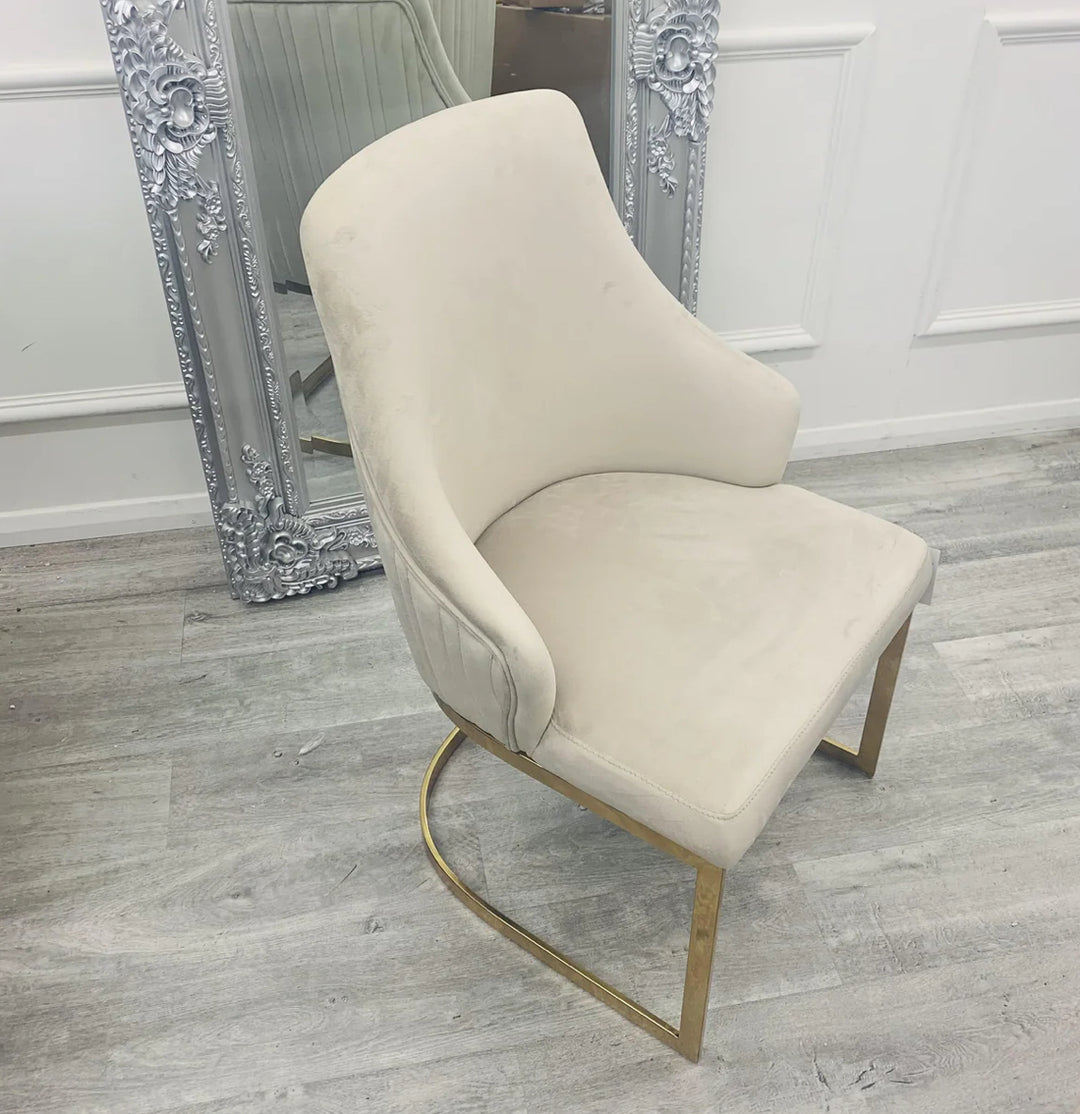 A pair of Chelmsford mink velvet dining chairs with gold stainless steel legs, featuring a ribbed stitch design on the backrest.