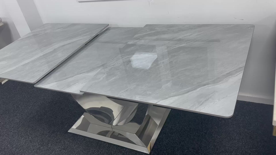 a light grey dining table with chrome leg in a beautiful dining room