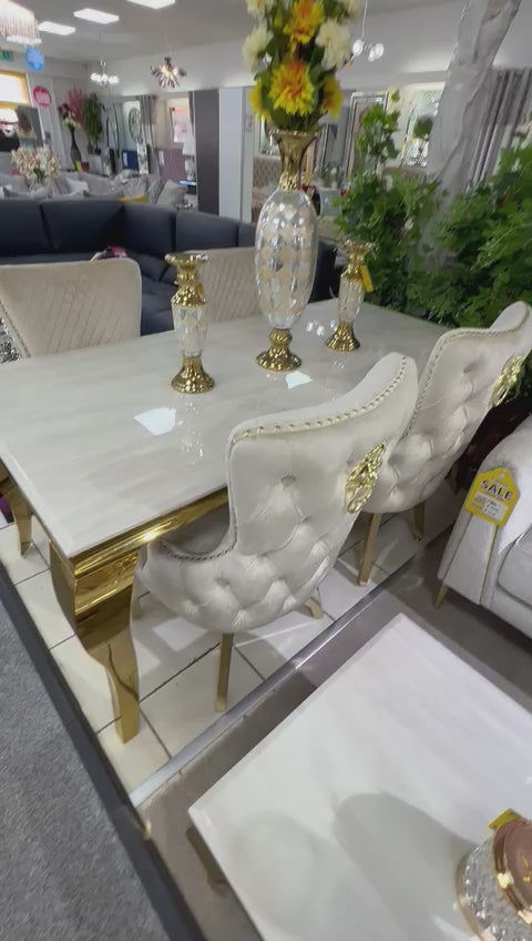 white and gold marble table and chair in a dining room