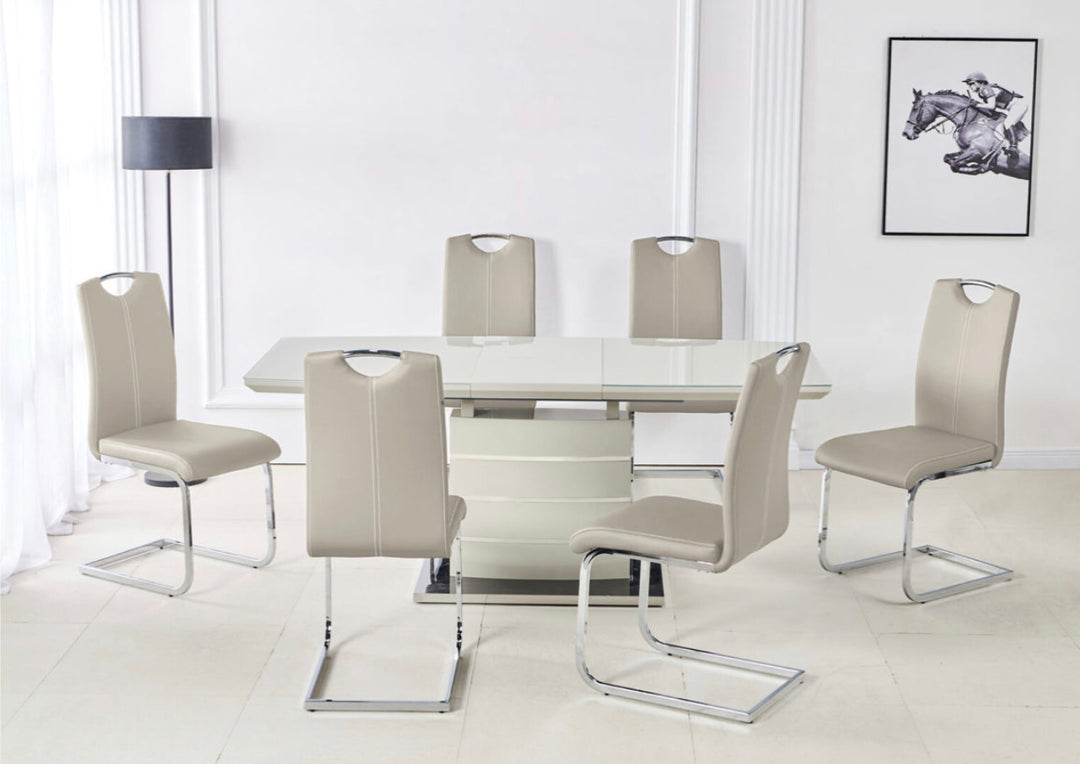 A set of dining furniture featuring a cappuccino-colored extendable dining table with a modern design, alongside four chairs with a metallic structure and upholstered seats in a light color.
