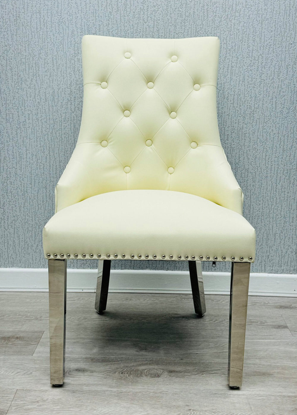  a cream color lion konker chair with chrome colour leg