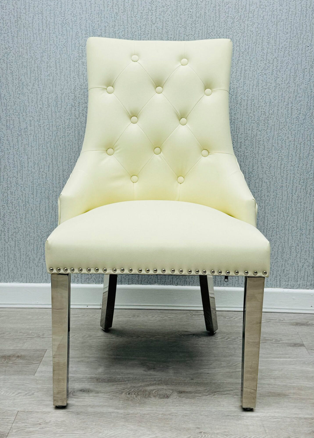  a cream color lion konker chair with chrome colour leg