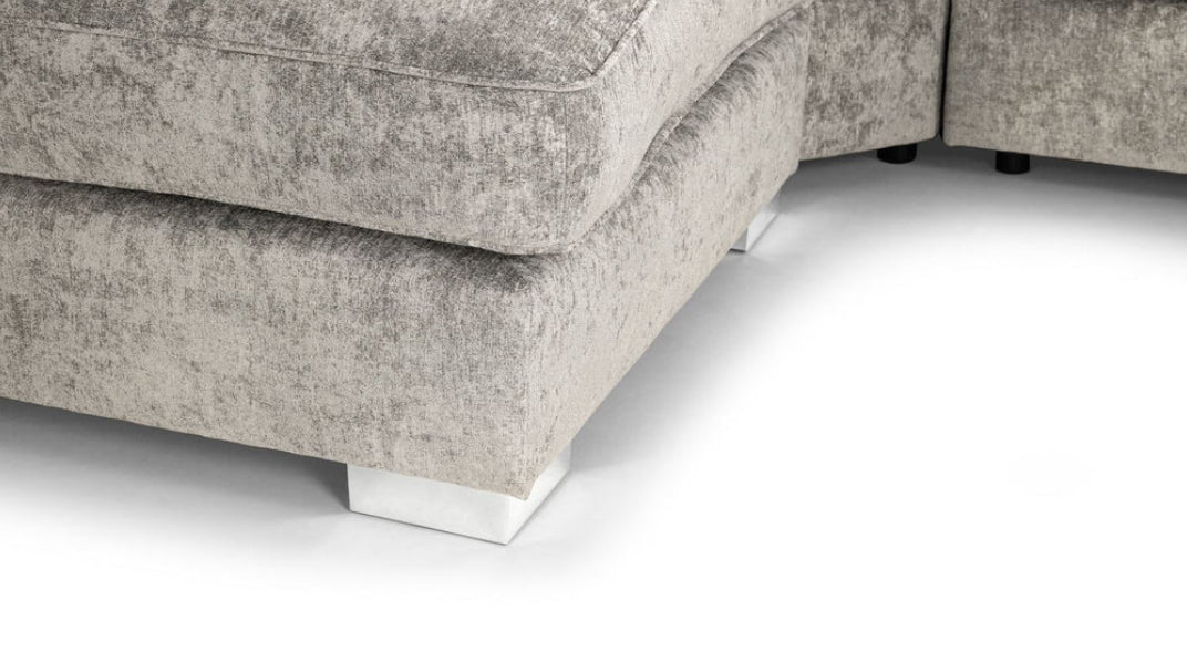 Close view A gray u-shaped corner sofa with truffle-colored upholstery, featuring a solid wooden frame and moveable footstools.