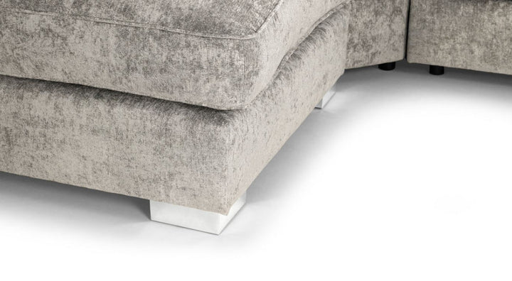 Close view A gray u-shaped corner sofa with truffle-colored upholstery, featuring a solid wooden frame and moveable footstools.