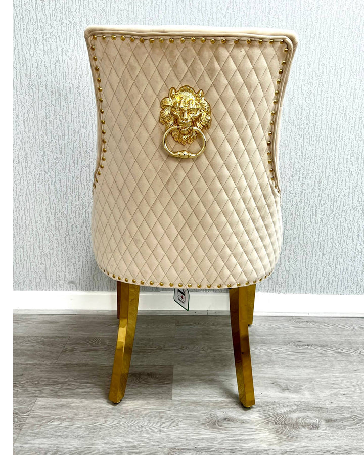 Decorative chair with quilted design and gold lion emblem on a neutral background